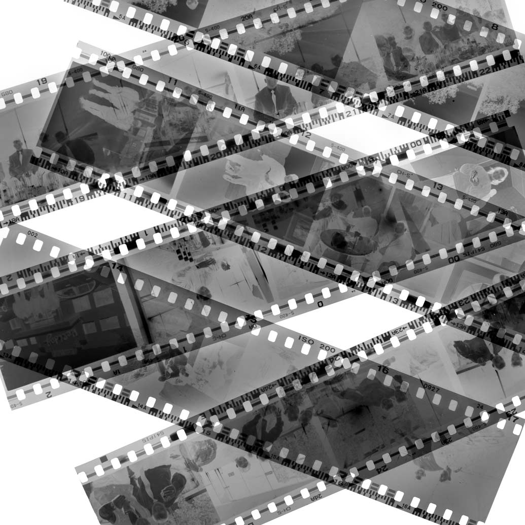 black and white negatives on a light table showing various scenes